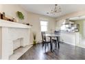 Cozy dining area with fireplace and open layout to a bright kitchen featuring stainless steel appliances at 1108 Sw Welch Sw St, Atlanta, GA 30310