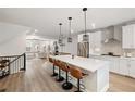 Modern kitchen with stainless steel appliances, quartz countertops, large island with bar seating, and hardwood floors at 1336 Rosen Rd, Brookhaven, GA 30319