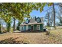 Two-story home featuring a covered front porch and a natural landscape setting at 1444 Norman Berry Dr, East Point, GA 30344
