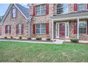 Brick home with red shutters and manicured landscaping at 117 Kiara Ln, Stockbridge, GA 30281