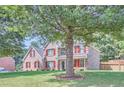Beautiful two-story house with red shutters, complemented by a lush green lawn and mature trees at 117 Kiara Ln, Stockbridge, GA 30281