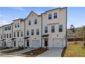 Attractive row of townhomes with stylish exteriors, individual garages, and landscaped front yards at 3200 Bateman Dr, Atlanta, GA 30354