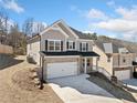 Two-story home with a brick facade, two-car garage, and well-maintained landscaping in a suburban neighborhood at 431 Crestmont Ln, Canton, GA 30114