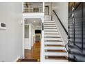 Inviting foyer with hardwood floors, staircase and view into the living area at 604 Ansley Villa Ne Dr, Atlanta, GA 30324