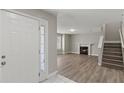 Inviting living room features a fireplace, wood floors, and staircase at 1088 Hubbard Sw St, Atlanta, GA 30310