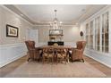Elegant dining room with tray ceiling, plantation shutters, and a wood table at 6715 Brookline Ct, Cumming, GA 30040