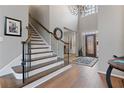 Open foyer with hardwood floors, statement lighting, and a staircase at 6715 Brookline Ct, Cumming, GA 30040