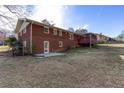 Back exterior of a brick home with fenced yard and deck at 6582 Malvin Dr, Mableton, GA 30168