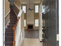 Inviting entryway with high ceilings, decorative staircase, and views of the living area with a fireplace at 875 Under Ct, Sugar Hill, GA 30518