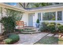 Inviting entrance featuring stone pathway, a bench, and lush landscaping at 2530 Parkdale Ne Pl, Atlanta, GA 30305