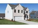 Two-story home with a brick facade, a two-car garage, manicured lawn and driveway at 708 Ocmulgee Xing, Locust Grove, GA 30248