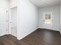 A bright mud room with a back door and luxury vinyl flooring at 708 Ocmulgee Xing, Locust Grove, GA 30248