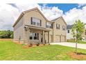 Beautiful new two-story home featuring brick and vinyl siding, and a well-maintained lawn at 1598 Sungrown Way, Mcdonough, GA 30253