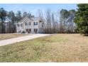 Beautiful two-story home featuring a large yard, attached two-car garage, and a long driveway at 225 Stonewood Ct, Temple, GA 30179