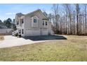 Spacious three-car garage with ample parking space and a long driveway in a beautiful two-story house at 225 Stonewood Ct, Temple, GA 30179