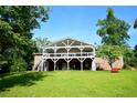 Expansive backyard view featuring a two-story home with a large covered deck, perfect for outdoor living at 2948 Legion Lake Rd, Douglasville, GA 30135
