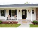 Inviting front porch with rocking chairs, a welcome mat, and classic architectural details at 2948 Legion Lake Rd, Douglasville, GA 30135