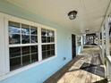 Inviting covered front porch featuring wood decking, white railings, and exterior lighting fixtures at 958 Fern Se Ave, Atlanta, GA 30315