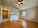 Open-concept living area with hardwood floors, vaulted ceilings, and views into the kitchen at 958 Fern Se Ave, Atlanta, GA 30315