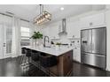 Modern kitchen with stainless steel appliances, white cabinets, and a large center island with bar stool seating at 3933 Danube Ln # 221, Atlanta, GA 30339