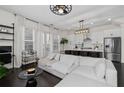 An open concept living space featuring living room and kitchen with hardwood floors and neutral tones at 3933 Danube Ln # 221, Atlanta, GA 30339