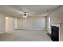Inviting living room with a fireplace, ceiling fan, and cozy carpeting at 4928 Bryant Dr, Snellville, GA 30039