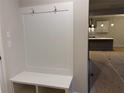 Convenient mudroom with a built-in bench, coat hooks, and storage, adjacent to the kitchen at 146 Riverbirch Way, Dallas, GA 30157