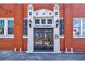 The entrance to the building featuring a black door, sidelights, and transom at 244 Peters St # 23, Atlanta, GA 30313