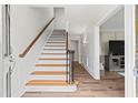 Bright foyer with hardwood floors, staircase with wood railing, and paneled walls at 2976 Wilsons Crossing Ct, Decatur, GA 30033