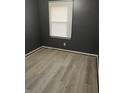 Cozy bedroom features neutral paint, wood-look floors, and a window for natural light at 650 Robert E Lee Pkwy, Jonesboro, GA 30238