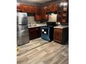 Traditional kitchen with stained wood cabinets, stainless steel fridge, and modern appliances at 650 Robert E Lee Pkwy, Jonesboro, GA 30238
