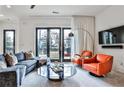 Comfortable living room with a plush couch, orange chairs, and a round glass table at 1100 Arkwright Se Pl # B, Atlanta, GA 30316
