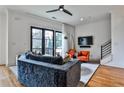 Bright living room with a large couch, modern furniture, and a sliding glass door at 1100 Arkwright Se Pl # B, Atlanta, GA 30316
