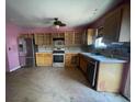 A kitchen featuring stainless steel appliances, wood cabinets, and tile floors at 304 Klinetop Dr, Mcdonough, GA 30253