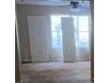 Bright living room with large windows, ceiling fan, and neutral walls at 304 Klinetop Dr, Mcdonough, GA 30253