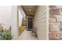 Home entryway featuring a covered porch with seating and stone veneer wall at 5015 Rapahoe Trl, Atlanta, GA 30349