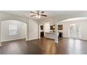Open floor plan with hardwood floors, arched doorways, and modern ceiling fan at 5015 Rapahoe Trl, Atlanta, GA 30349