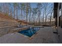 Beautiful outdoor pool area with stone patio, lounge chairs, and professional landscaping at 101 Bevil Ridge Se Rd, Emerson, GA 30137
