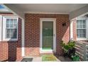 Cozy front porch with brick detail, plants, and a 'Welcome' mat at 1475 Elizabeth Ln, East Point, GA 30344