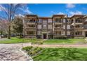 View of a stately brick apartment building with multiple stories, charming balconies, and manicured lawns at 198 Ponce De Leon Ne Ave # 2A, Atlanta, GA 30308