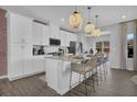 Bright, modern kitchen featuring white cabinets, granite countertops, and a stylish island at 235 Commons Ave, Woodstock, GA 30188