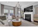 Cozy living room with fireplace, large windows, and neutral decor for a relaxing atmosphere at 235 Commons Ave, Woodstock, GA 30188