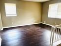 A cozy living room with laminate flooring and a view of the staircase at 7411 Windsor Ct, Riverdale, GA 30274