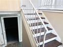 Staircase featuring white railings and steps leading to the upper level at 7411 Windsor Ct, Riverdale, GA 30274