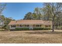 Ranch style home with a long porch and mature trees at 12142 Panhandle Rd, Hampton, GA 30228