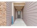 Entryway features a covered porch, stylish front door, and attractive siding at 2275 W Village Se Ln, Smyrna, GA 30080