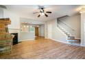Bright living room featuring wood floors, a fireplace, and an open staircase at 2280 Whitestone Pl, Alpharetta, GA 30005