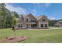 Inviting two-story home with brick and siding exterior, situated on a well-maintained lawn at 30 Homesite Cooper E Cv, Fayetteville, GA 30215