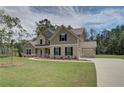 This two-story home features brick accents, neutral siding and an attached two car garage at 30 Homesite Cooper E Cv, Fayetteville, GA 30215
