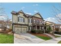 Two-story home with a basketball hoop over the garage, brick and siding, and a well-manicured lawn at 4492 Arbor Crest Ct, Suwanee, GA 30024